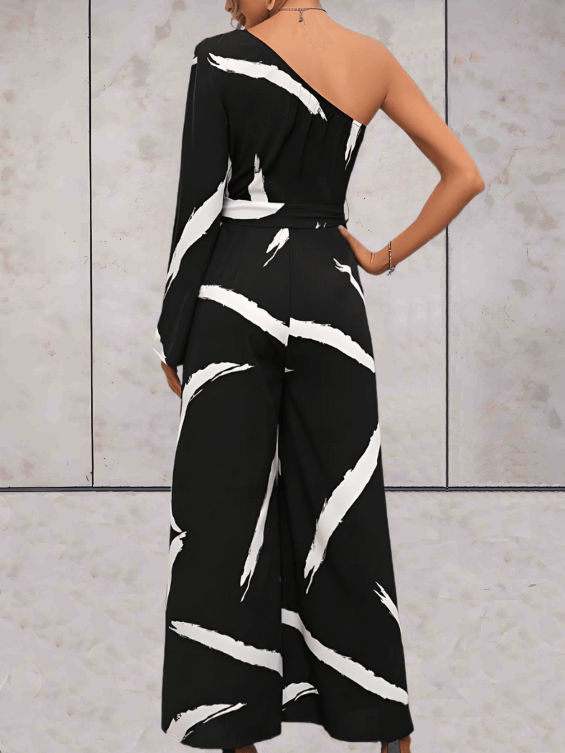 Bailey - Zwarte jumpsuit met witte verfstrepen, een off-shoulder ontwerp en een ontwerp met lange mouwen - Sky-Sense